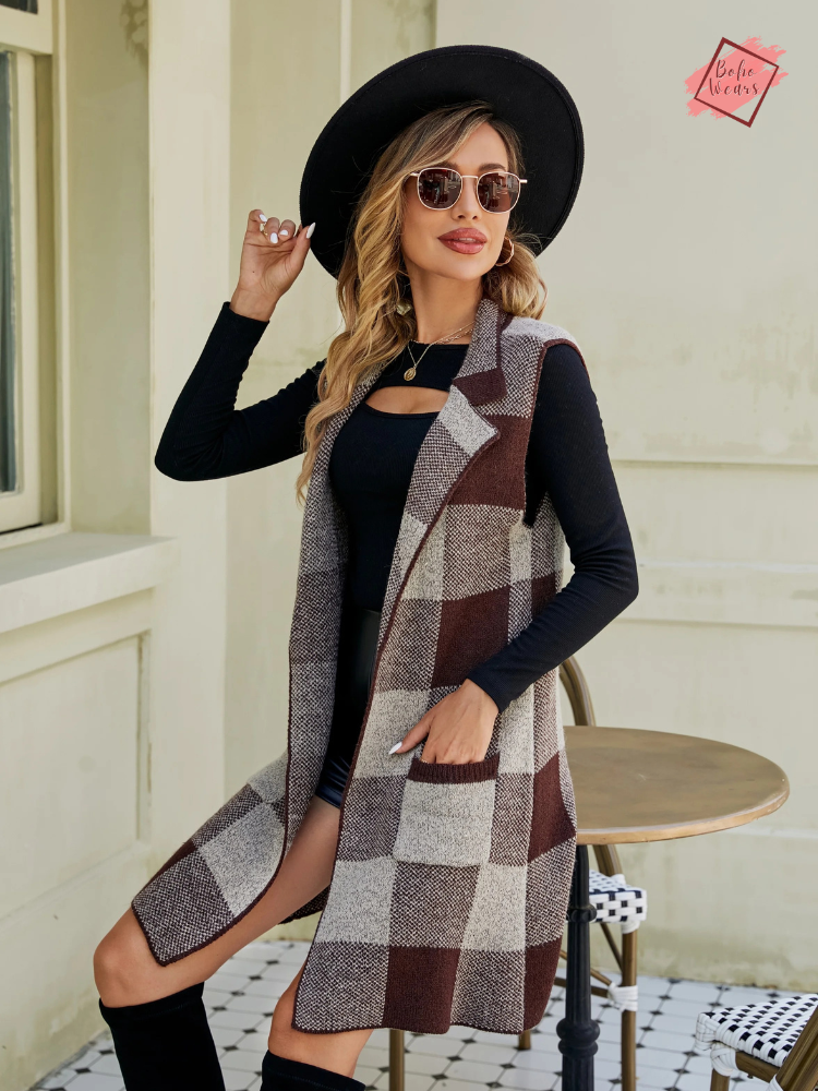 Stylish woman dressed in a plaid vest with a turn-down collar, gray top, and sunglasses for a chic autumn look.
